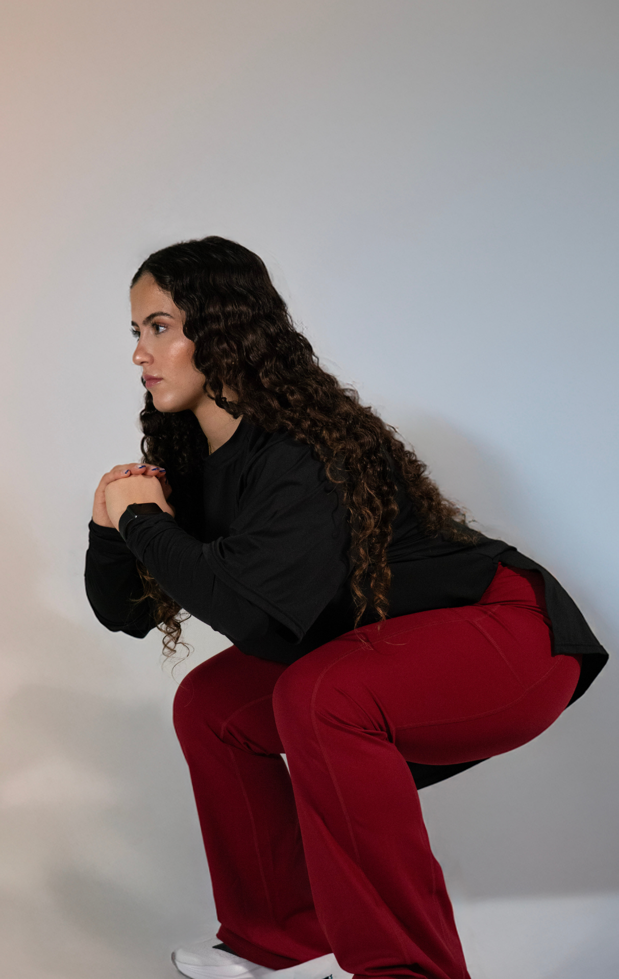 Woman wearing modest black oversized active top with flare pants — TURAYA MOVE