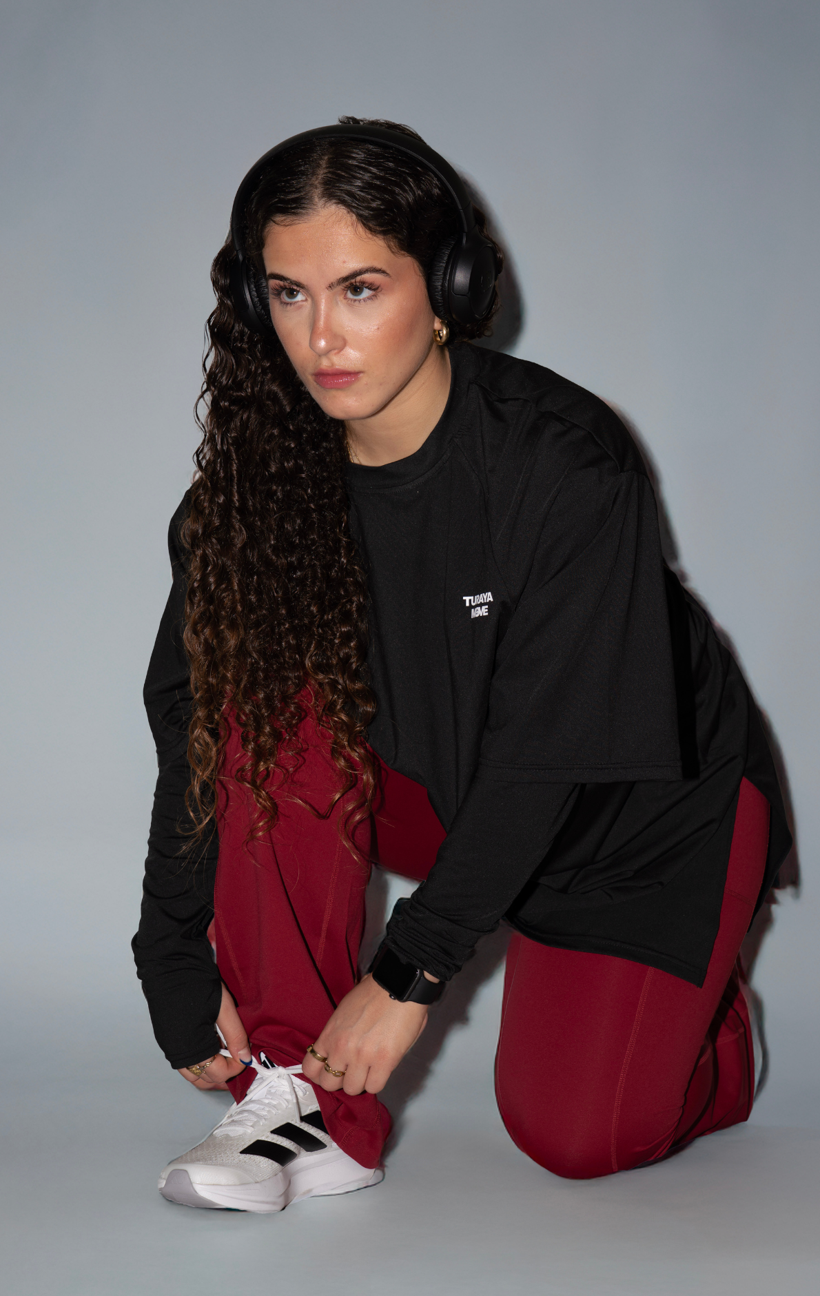 Woman wearing modest black oversized active top with flare pants — TURAYA MOVE