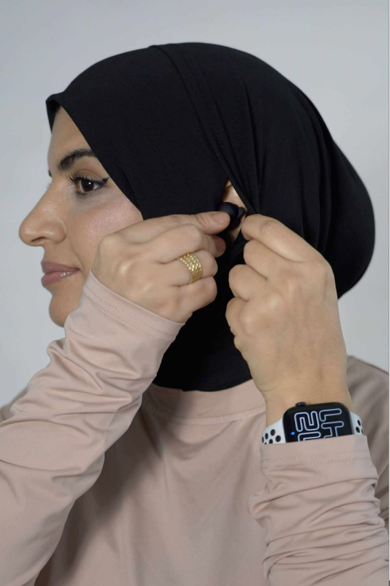 Muslim woman in black sport hijab wearing beige modest active top — TURAYA MOVE Canada