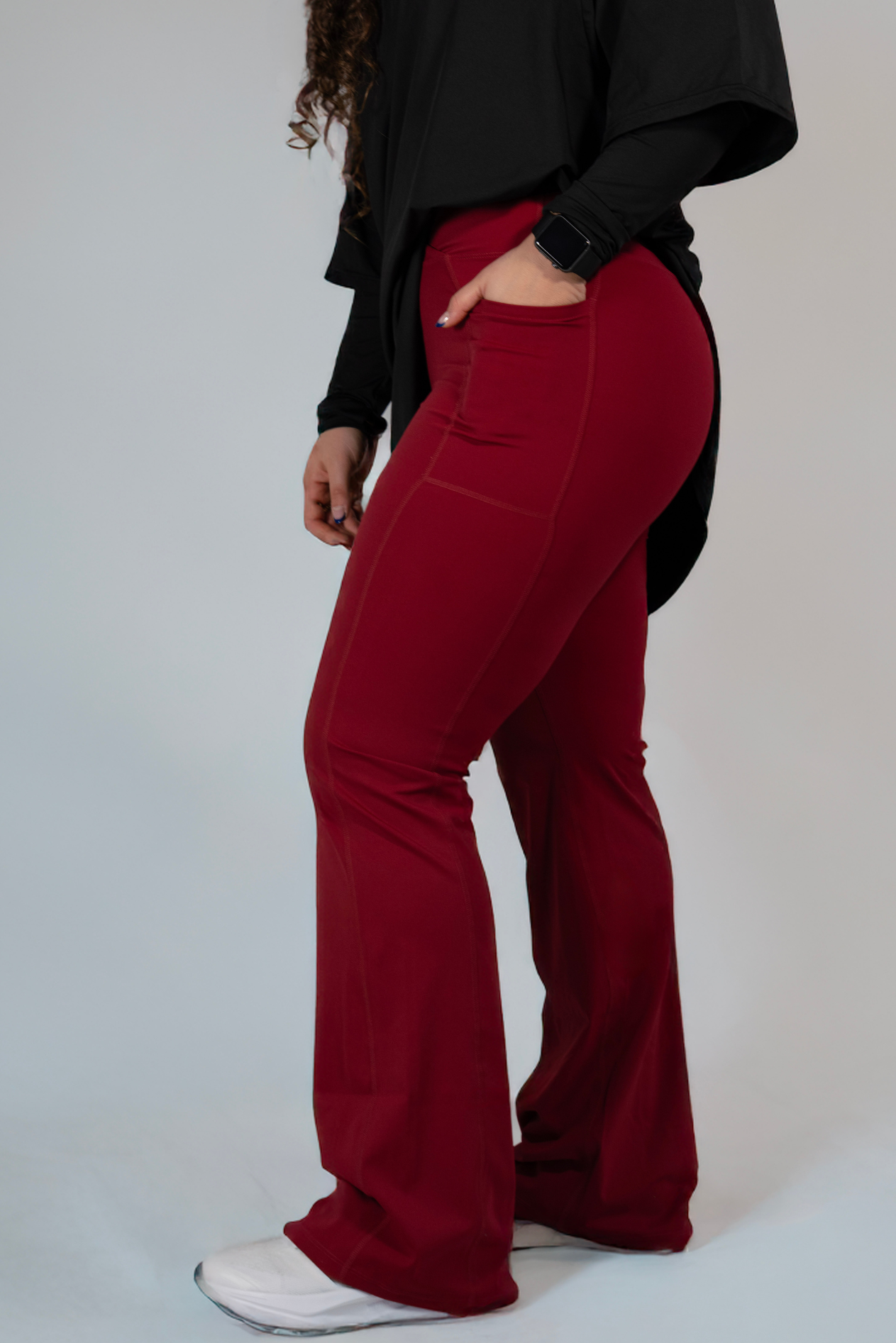 Woman wearing modest black oversized active top with flare pants — TURAYA MOVE