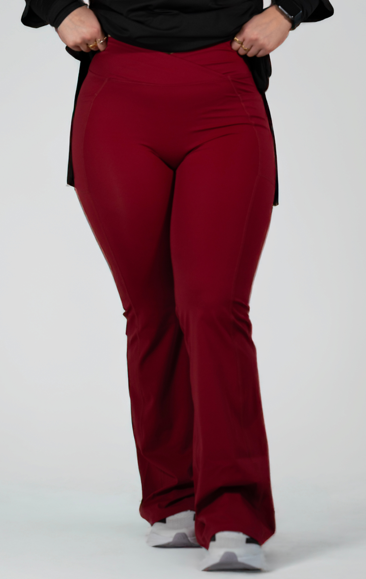 Woman wearing modest black oversized active top with flare pants — TURAYA MOVE